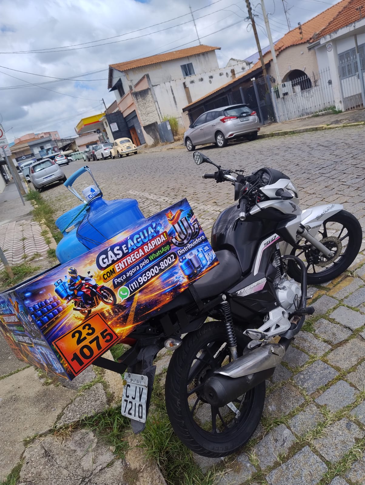 Moto da JJ Distribuidora carregando galão de água em Atibaia